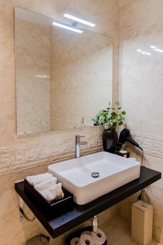 a bathroom with a white sink and a mirror at La Casiña in A Coruña