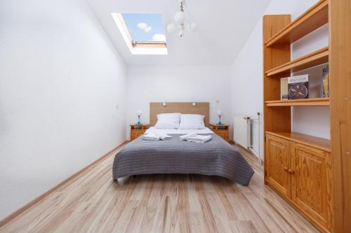 a bedroom with a bed and a book shelf at Ośrodek Perełka Bieszczady in Cisna