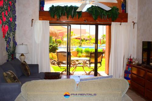 una sala de estar con 2 sofás y una puerta corredera de cristal en Marina Pinacate A-114 en Puerto Peñasco