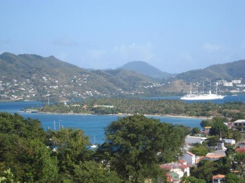 a view of a bay with a boat in the water at Habitation Bellevue in Sainte-Anne