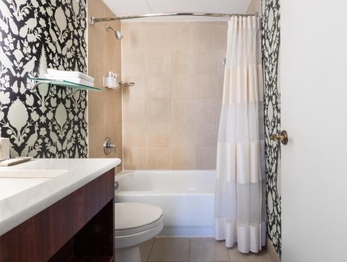 a bathroom with a toilet and a shower curtain at Historic Inns of Annapolis in Annapolis