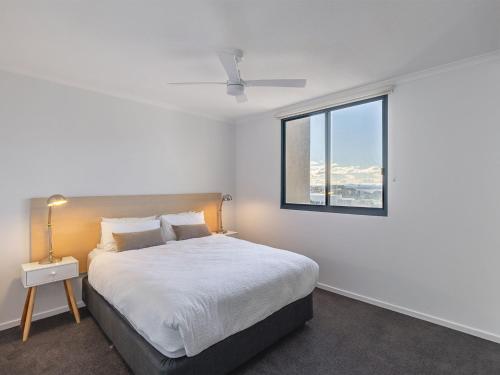 a bedroom with a large bed and a window at The Landmark 211 Resort Style holiday with pool games room and restaurant in Nelson Bay