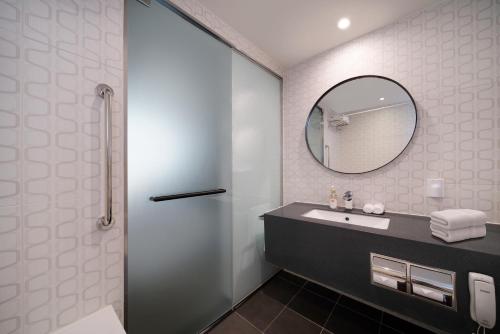 a bathroom with a sink and a mirror at Travelodge Myeongdong City Hall in Seoul