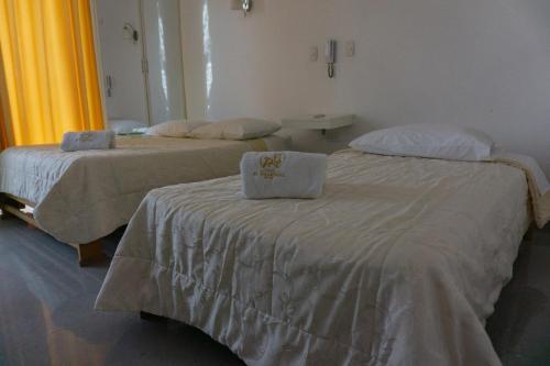 two beds in a hospital room with towels on them at El Gamonal - Paracas in Paracas