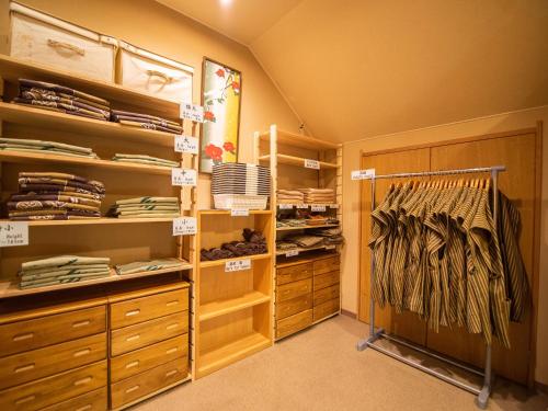 a walk in closet with wooden cabinets and drawers at Ryokan Hakura in Yamanouchi