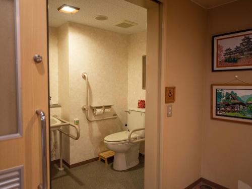 a bathroom with a white toilet in a room at Ryokan Hakura in Yamanouchi