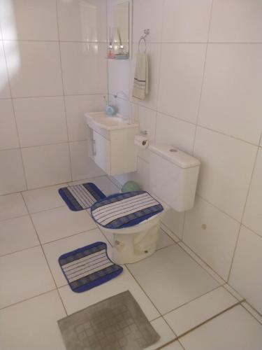 a white bathroom with a toilet and a sink at Casa da Lagoa Azul - Tambaquis - Abaís in Estância
