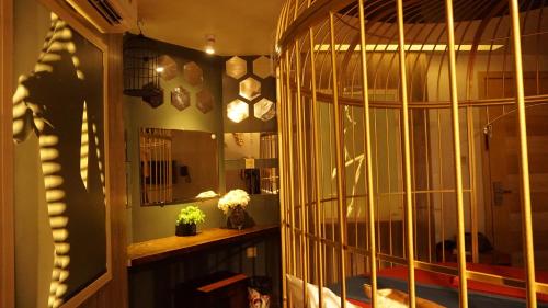a room with a large bird cage in a room at Cozi 9 Hotel - Theme Hotel in Kiến An