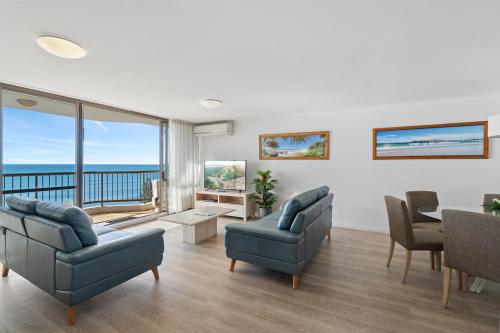 a living room with a view of the ocean at Seaview Resort in Mooloolaba