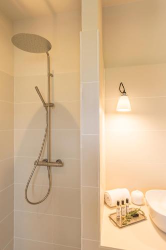 a bathroom with a shower and a sink at Boutique hôtel Château Rouher in Propriano