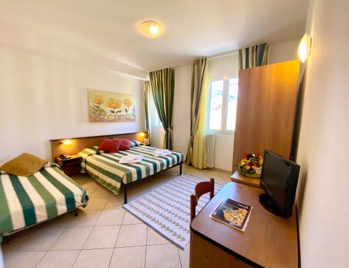 Un ou plusieurs lits dans un hébergement de l'établissement Albergo Villa Ada