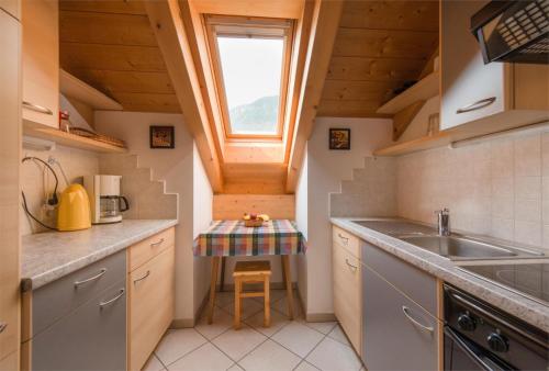 a small kitchen with a sink and a window at Dissertorihof in Andrian