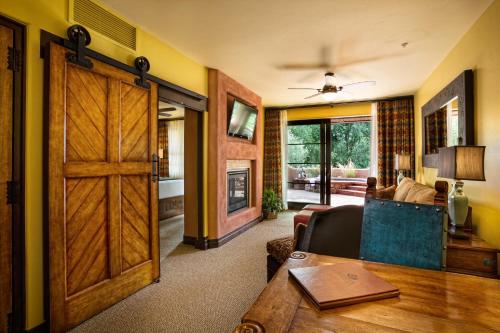 a living room with a wooden door and a couch at Gateway Canyons Resort, a Noble House Resort in Gateway