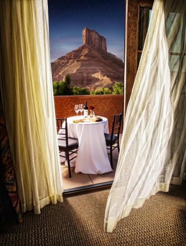a table with a view of a mountain from a balcony at Gateway Canyons Resort, a Noble House Resort in Gateway