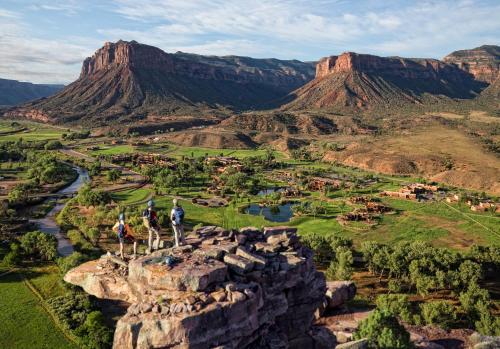 people standing on the edge of a mountain overlooking a valley at Gateway Canyons Resort, a Noble House Resort in Gateway