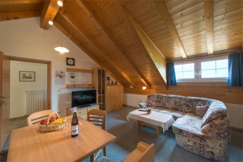 a living room with a couch and a table at Dissertorihof in Andrian