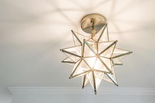 a star light hanging from a ceiling at Garden Level Flat in 1885 Queen Anne Victorian Cottage in Alameda in Alameda