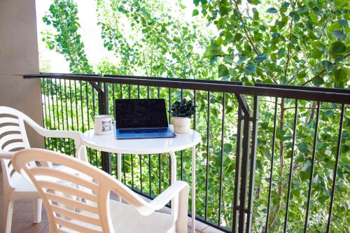 a laptop computer sitting on a table on a balcony at Hotel Loretta & Dependance in Cervia