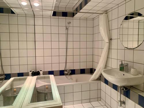 a bathroom with a bath tub and a sink at Jordan Canal Studio in Amsterdam