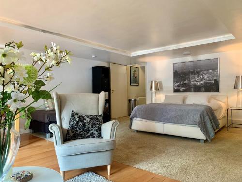 a bedroom with a bed and a chair and a couch at Jordan Canal Studio in Amsterdam