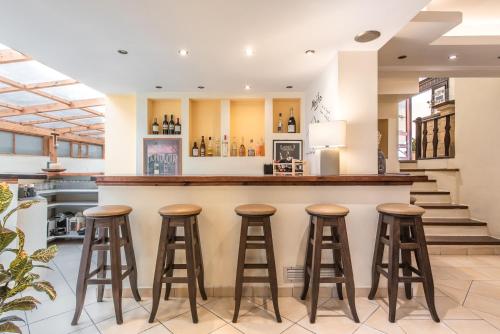 a bar in a restaurant with stools at Yria Hotel in Zakynthos Town