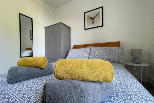 a bedroom with a bed with two pillows on it at No 10 Immaculate City Centre, Top Floor 2 Bed Flat with Free Parking in Inverness