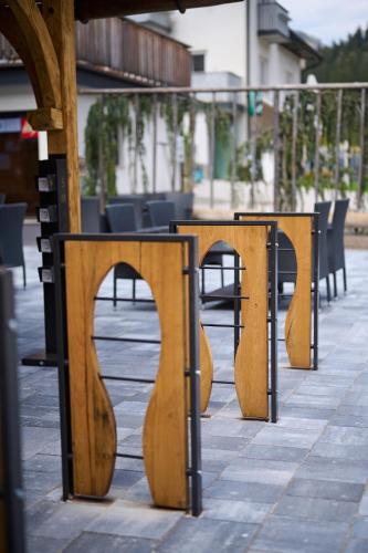 a row of wooden benches sitting on a sidewalk at Guesthouse S in Luče