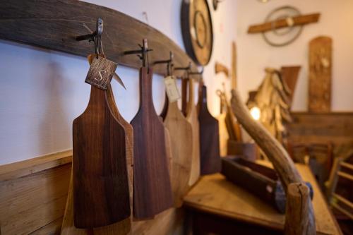 a row of wooden umbrellas hanging on a wall at Guesthouse S in Luče