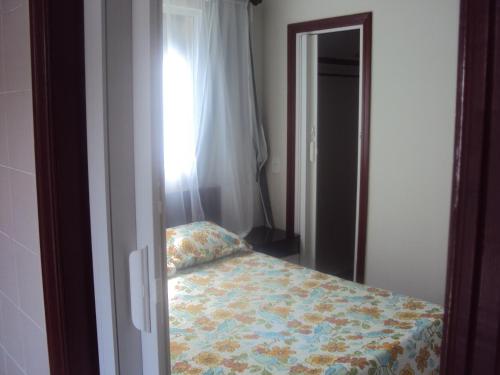 una camera da letto con un letto con una coperta a fiori di Sweet Rio Residence Taquara a Rio de Janeiro