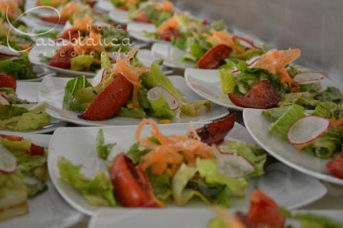 a row of plates of food on a table at Hotel Casablanca Xicotepec in Xicotepec de Juárez
