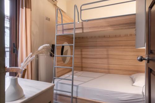 a bedroom with bunk beds and a desk at Yria Hotel in Zakynthos Town