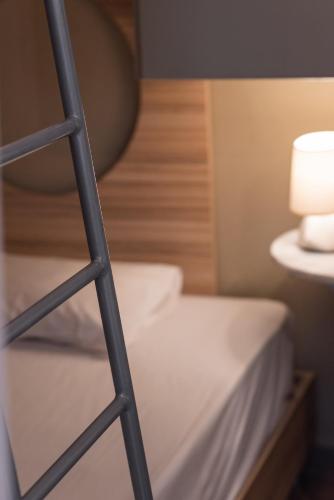 a ladder next to a bed in a room at Yria Hotel in Zakynthos Town