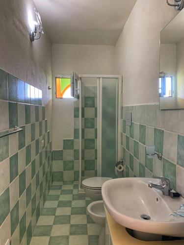 a bathroom with a sink and a toilet at Affittacamere La Petra Longa in San Teodoro