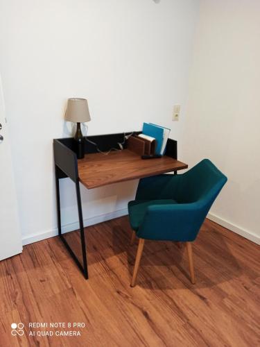 a desk with a chair and a cat sitting at it at Gästezimmer / Weingut Peter in Wachenheim an der Weinstraße