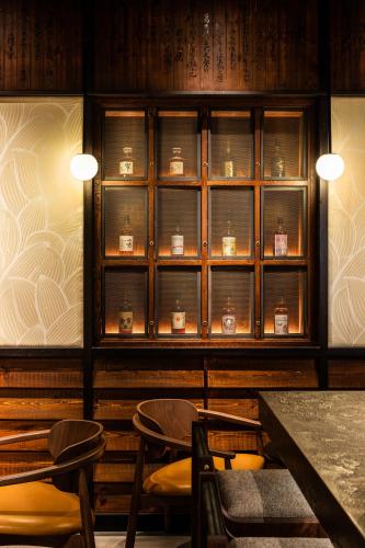 a room with tables and chairs and a shelf with clocks at The Prince Akatoki London in London