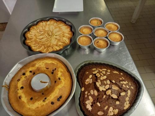 a table with two donuts and cupcakes on it at Hotel Serafini Misano Adriatico in Misano Adriatico
