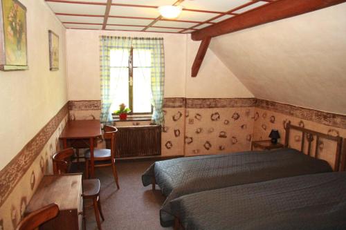 a bedroom with two beds and a desk and a window at Villa Sunshine / Slunečna Vila in Krásná Lípa
