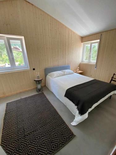 a bedroom with a large bed and a rug at Perfect for quiet vacation with family and friends in Setúbal