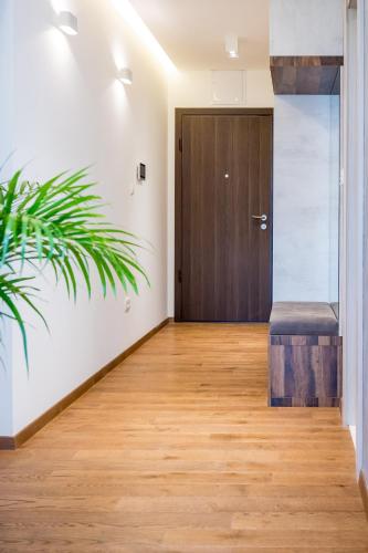 a hallway with a wooden door and a plant at Montefiori Lux View Apartment in Kotor