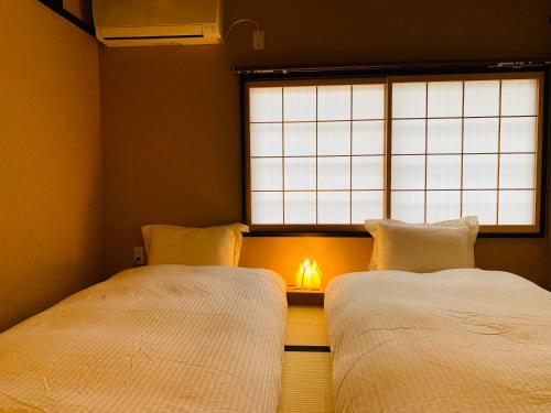 Letto o letti in una camera di 京町屋の宿 天神庵