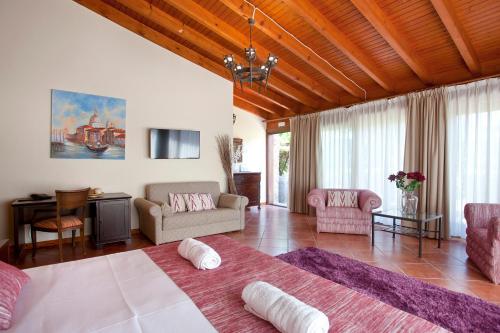 a bedroom with a large bed and a living room at S'Hort de Son Caulelles - Adults Only in Marratxí 
