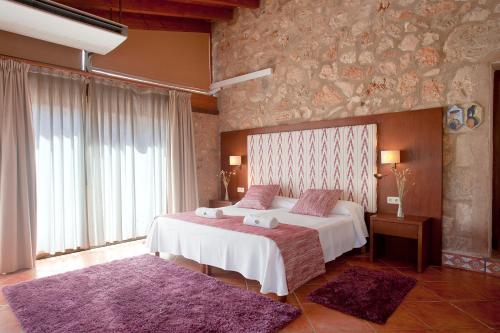 a bedroom with two beds with purple rugs at S'Hort de Son Caulelles - Adults Only in Marratxí 