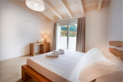 a bedroom with a bed and a large window at Villa Summer Luxury Apartment in Olbia