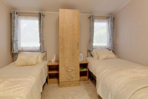 A bed or beds in a room at St Helens Coastal Resort 