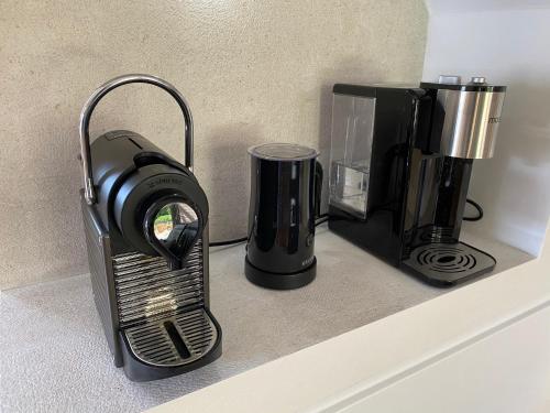 a coffeemaker and a coffee maker on a counter at "ZeeLandZon" Holiday home by the lake with Jacuzzi and Sauna in Herkingen