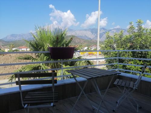 a chair and a table on a balcony with mountains at Orange&Lemon Villas Çamyuva in Kemer