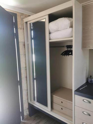 a white cabinet with a glass door in a kitchen at Villa fotini in Kallithea Halkidikis