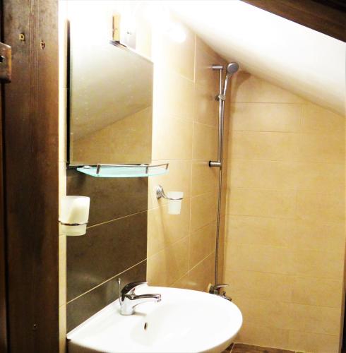 a bathroom with a sink and a mirror at Стаи за гости The Old House in Velingrad