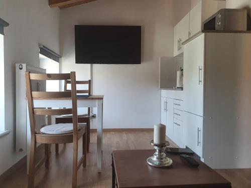 a kitchen with a table and a dining room at Eldenhof in Plau am See