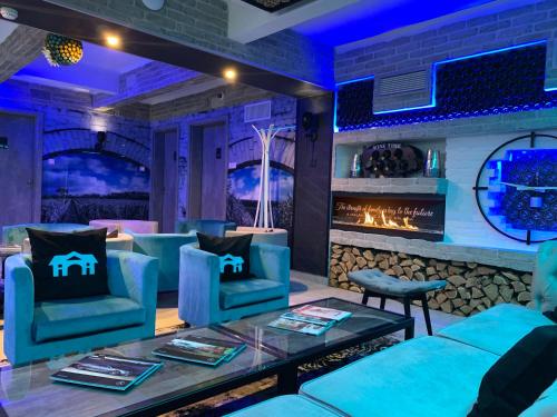 a lobby with blue chairs and a fireplace at Smart Hotel Budapest & Apartments in Budapest